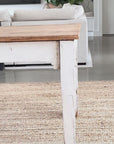 grey stripe oilcloth being put on a rustic wooden table